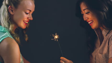 Young-women-celebrating-holding-spakler-cinemagraph-seamless-loop